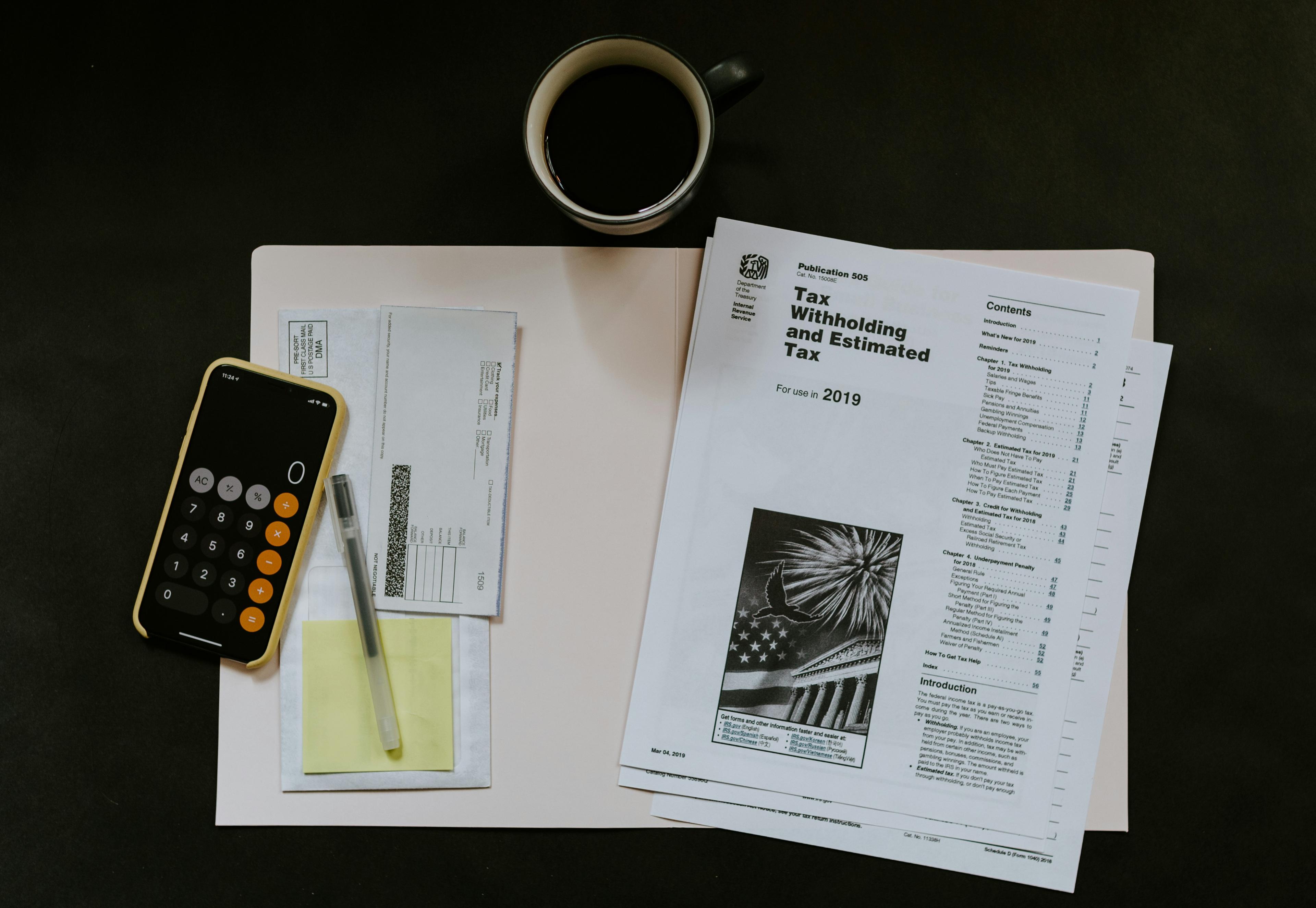 Tax documents and calculator on desk