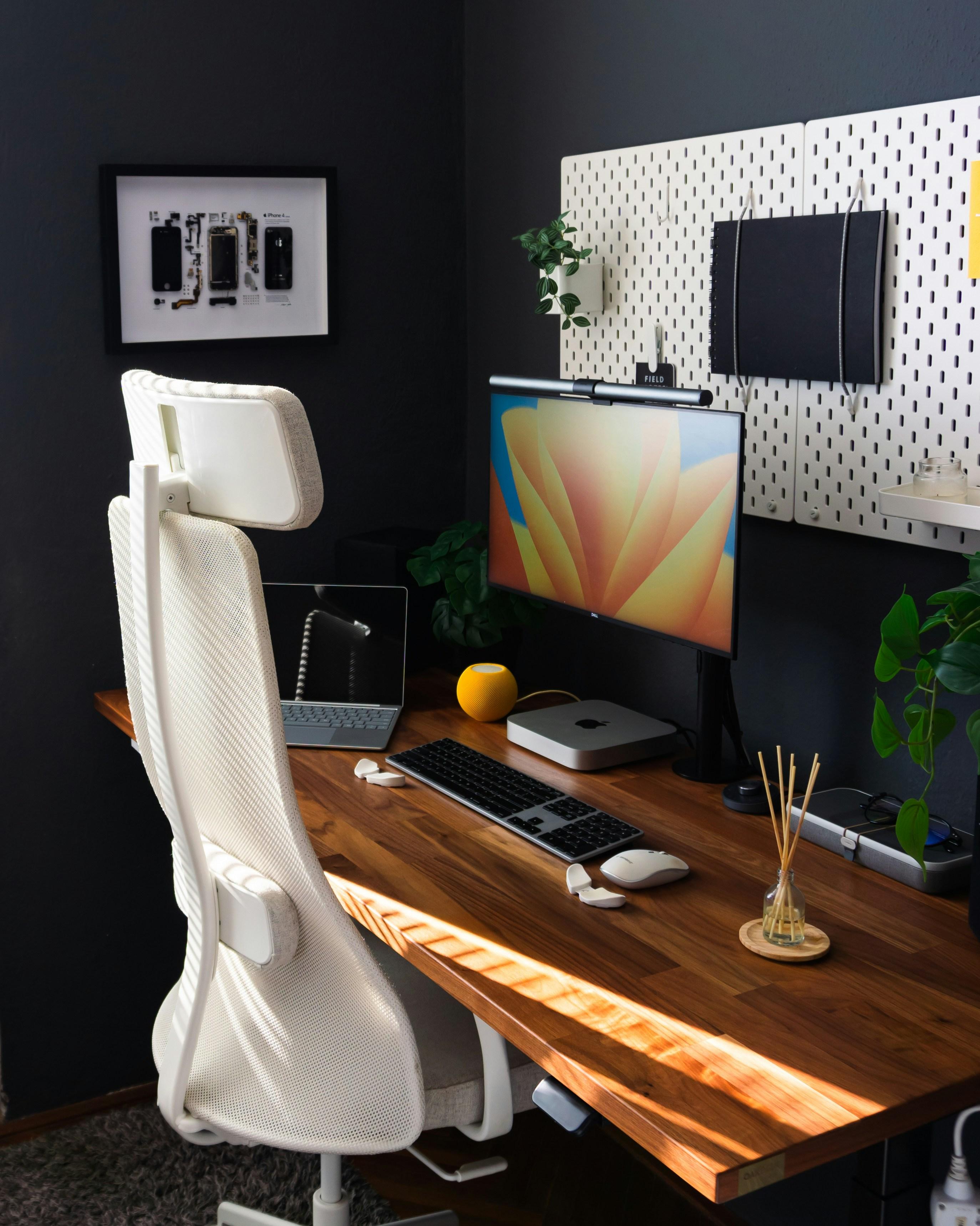 Person working on laptop at modern home office desk